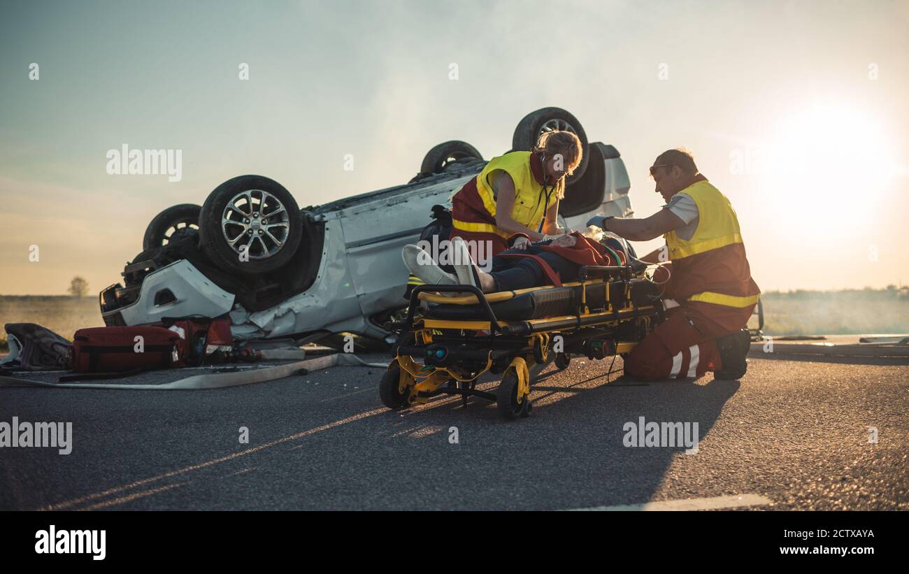 On the Car Crash Traffic Accident Scene Paramedics Saving Life of a