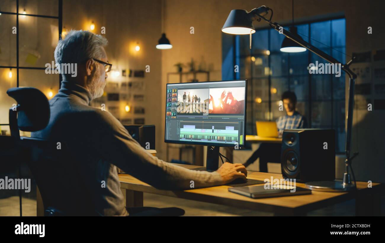 Evening in Creative Office Professional Middle Aged Videographer Works