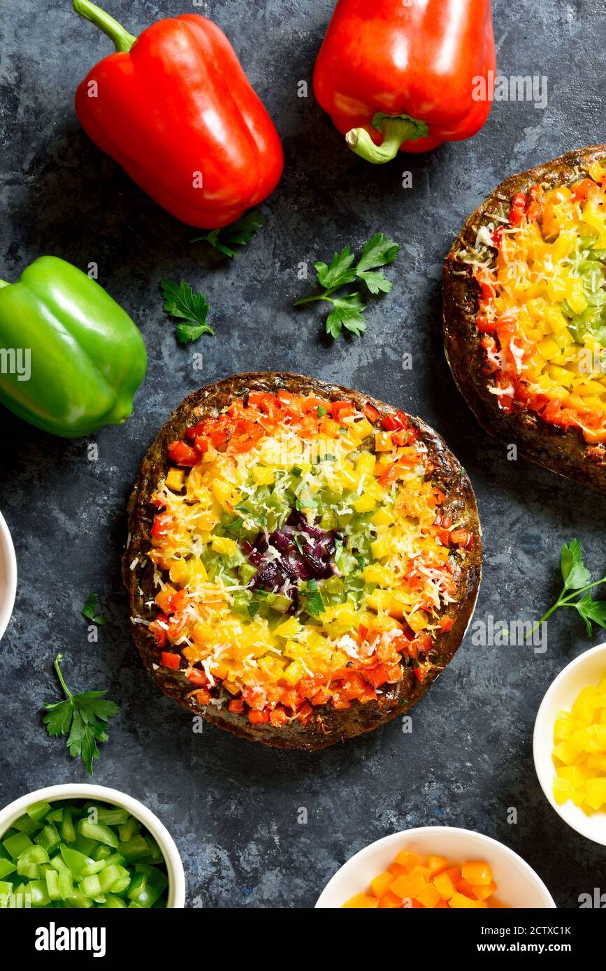 Rainbow veggie bell peppers pizza crust on blue stone background. Vegetarian vegan or healthy food concept. Top view, flat lay Stock Photo