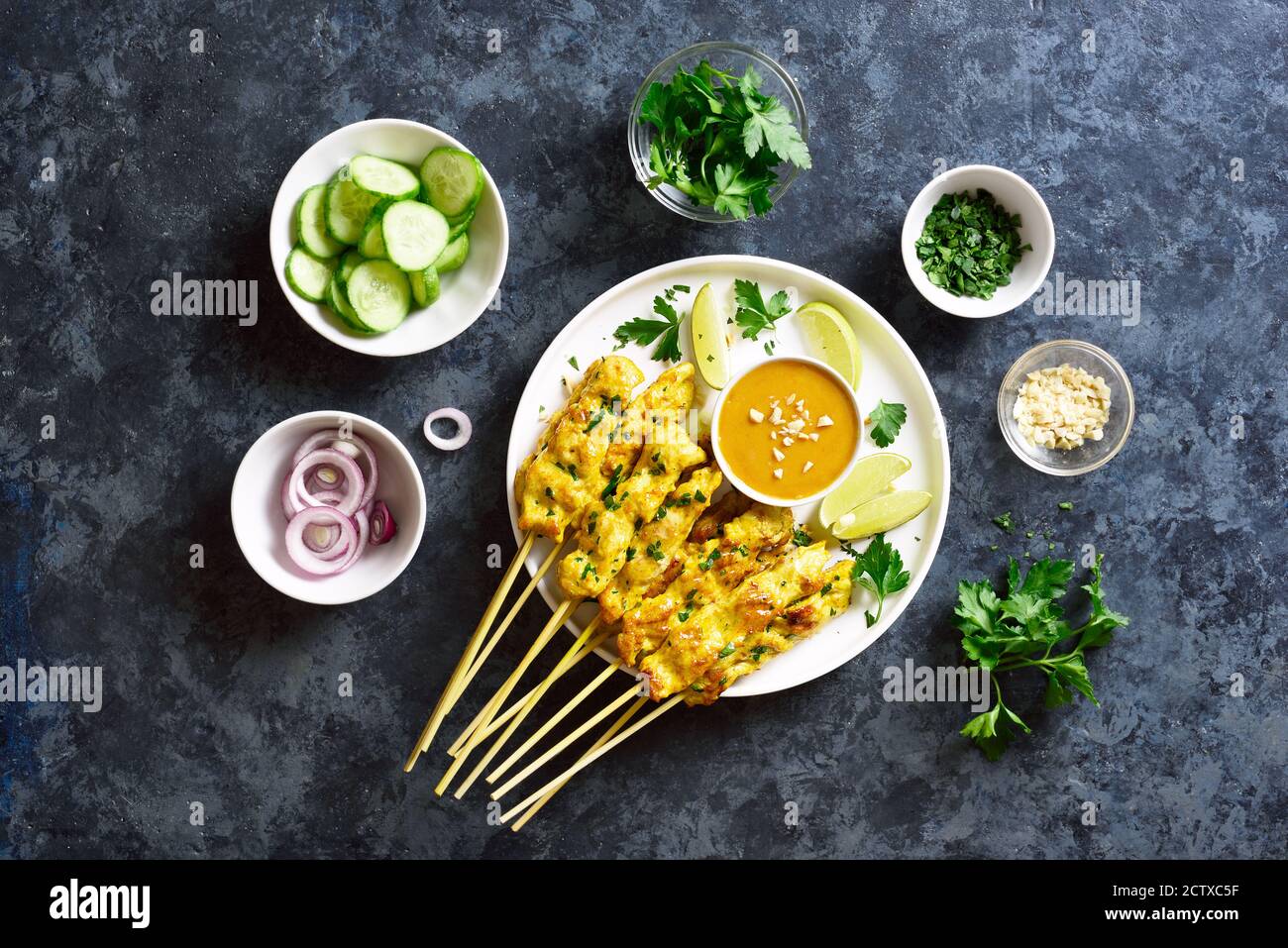 Chicken satay with peanut sauce. Grilled chicken skewers served with