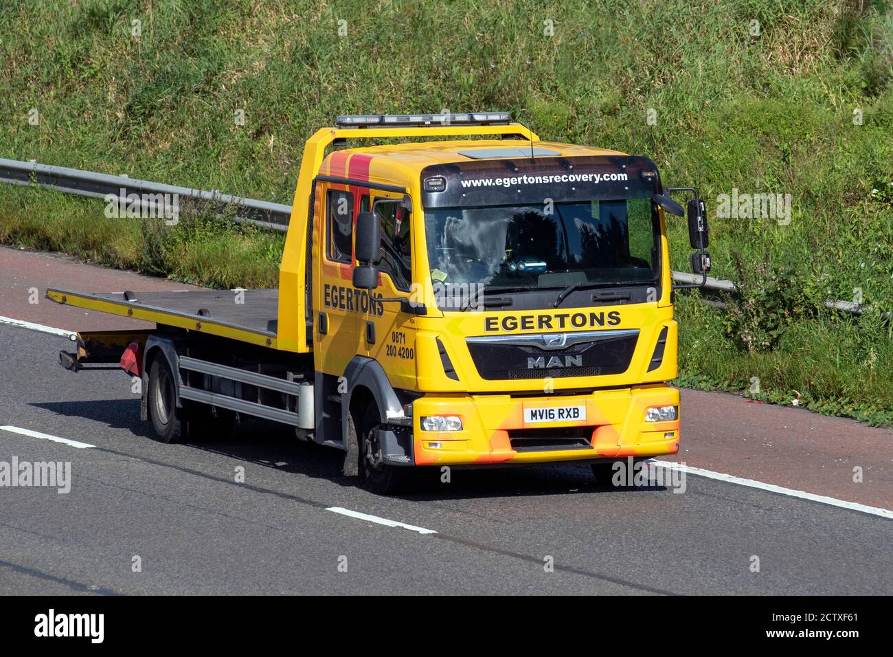 2016 yellow Man TGL Egertons Breakdon Recovery lorry;  Haulage delivery trucks, lorry, transportation, truck, MAN vehicle, delivery, commercial transport industry on the M6 at Lancaster, UK Stock Photo