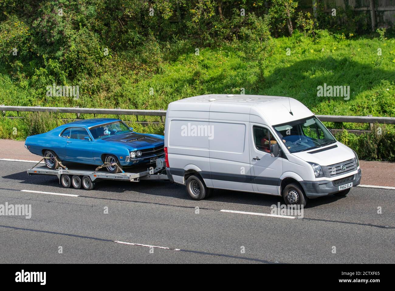 1970 70s blue American Fairlane RamAir 429 on car trailer being towed on tghe M6 motorway near Manchester, UK Stock Photo