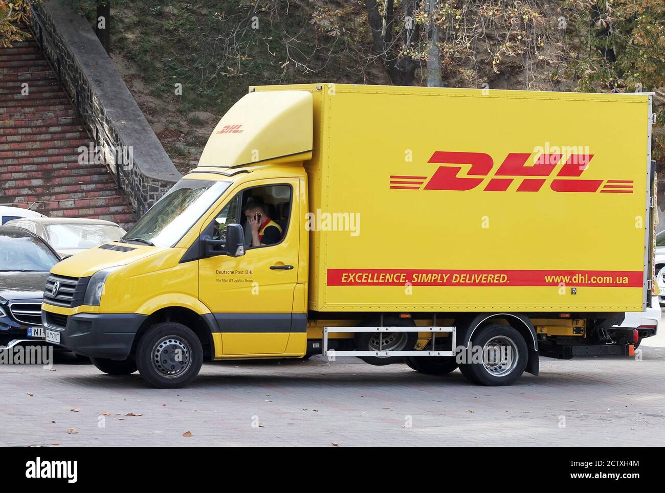 A truck of DHL courier, parcel, and express mail service of the German  logistics company Deutsche Post DHL is parked on the street Stock Photo -  Alamy