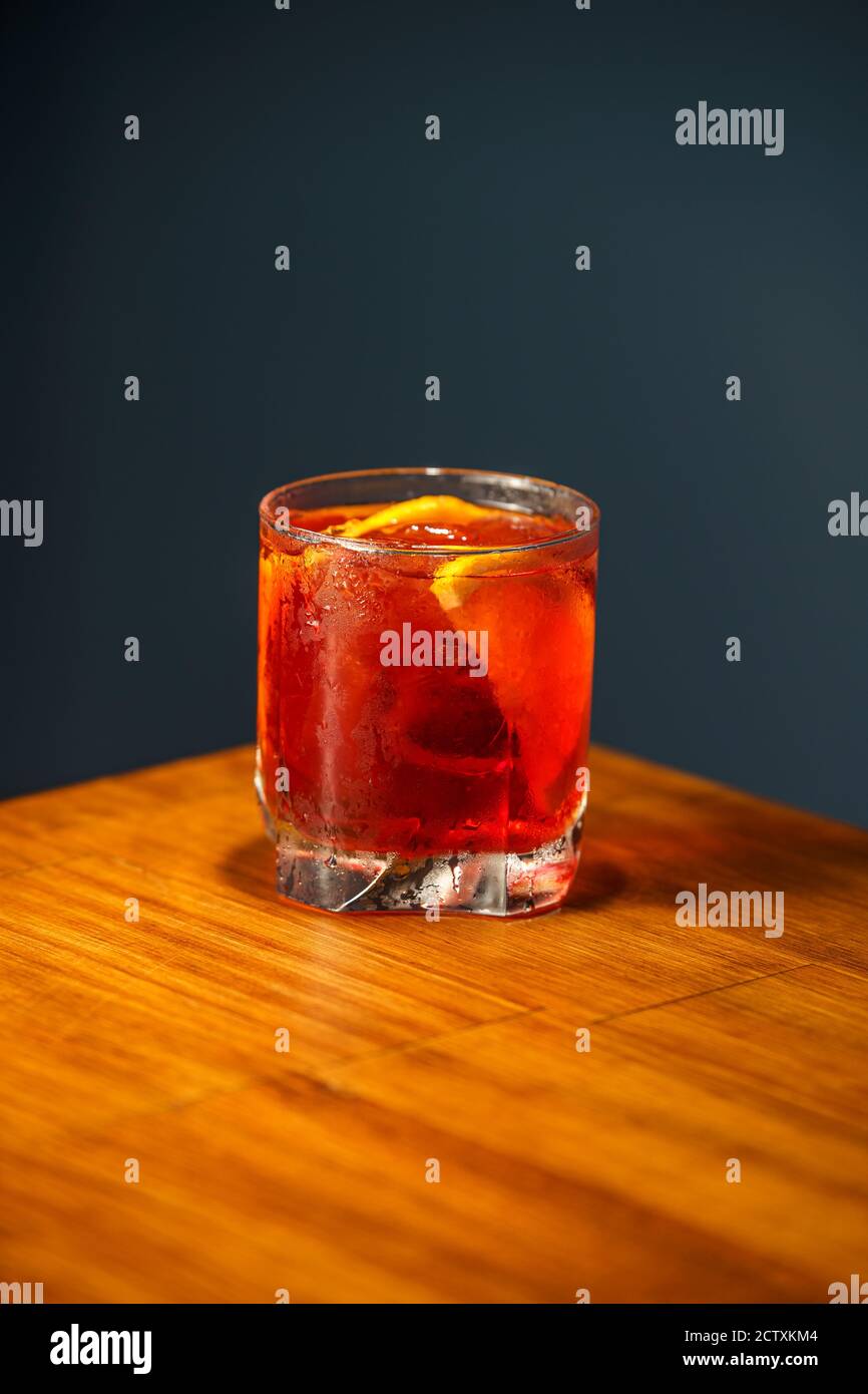 Negroni Cocktail. Gin, Campari and Martini Rosso. Cocktail on wooden bar. Stock Photo