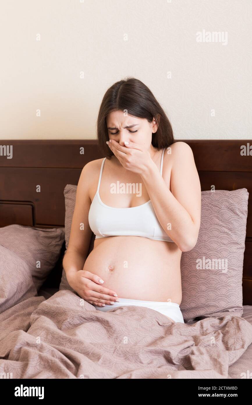 Pregnant suffering with nausea. Pregnancy symptoms, expectation