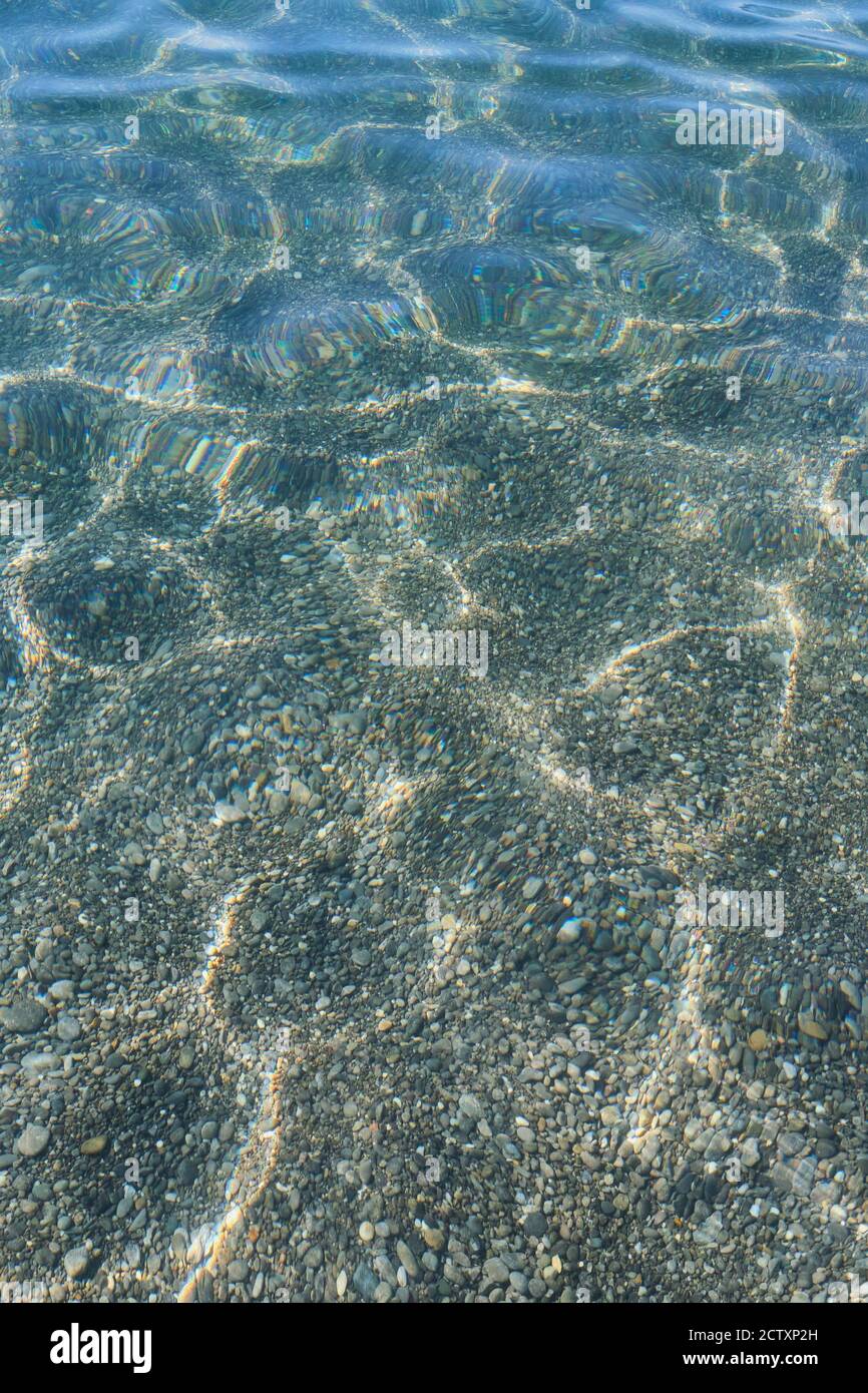 Abstract background of transparent sea water on the rocky beach with ...