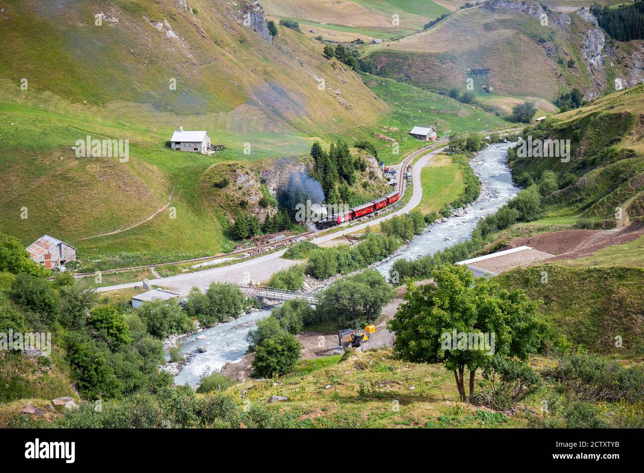 Realp, Furka - July 15, 2018: the vintage steam train going through the Raelp valley in Canton Uri, Switzerland Stock Photo