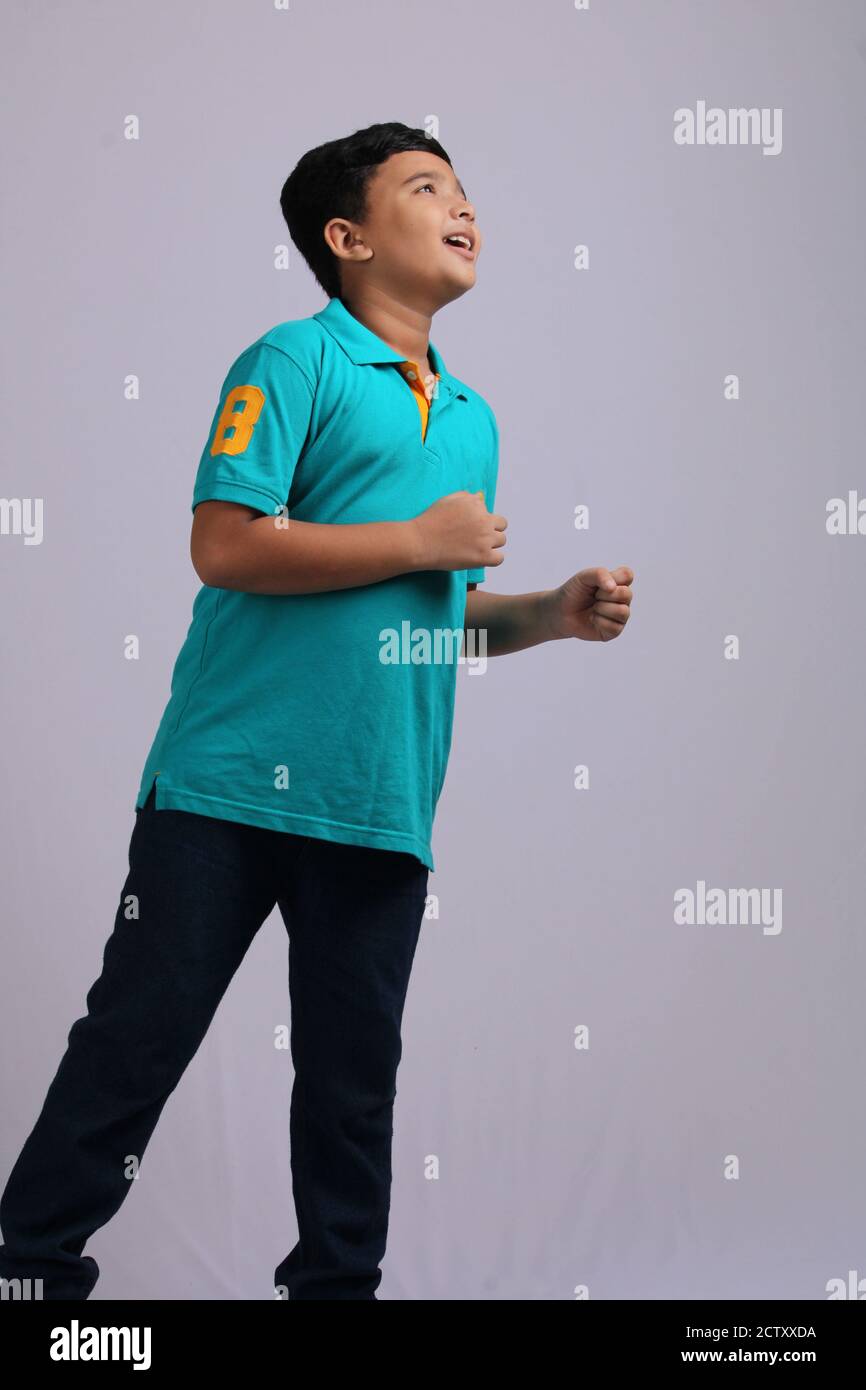 Cute Indian boy in running pose Stock Photo