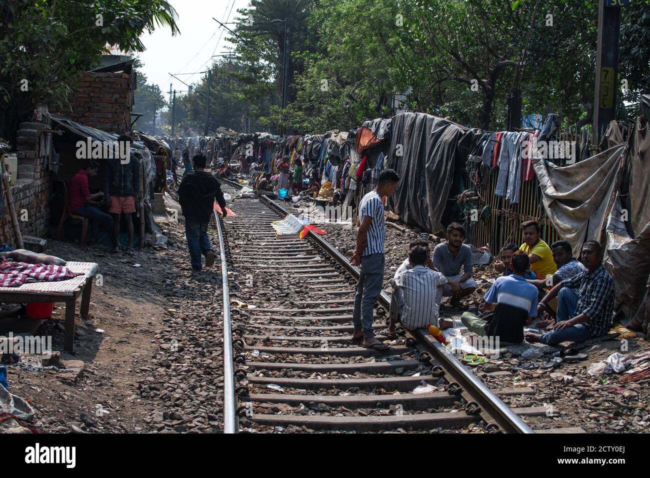 Kolkata, India - February 2, 2020: Unidentified people´s everyday life next to the active railroad in the slums on February 2, 2020 in Kolkata, India Stock Photo