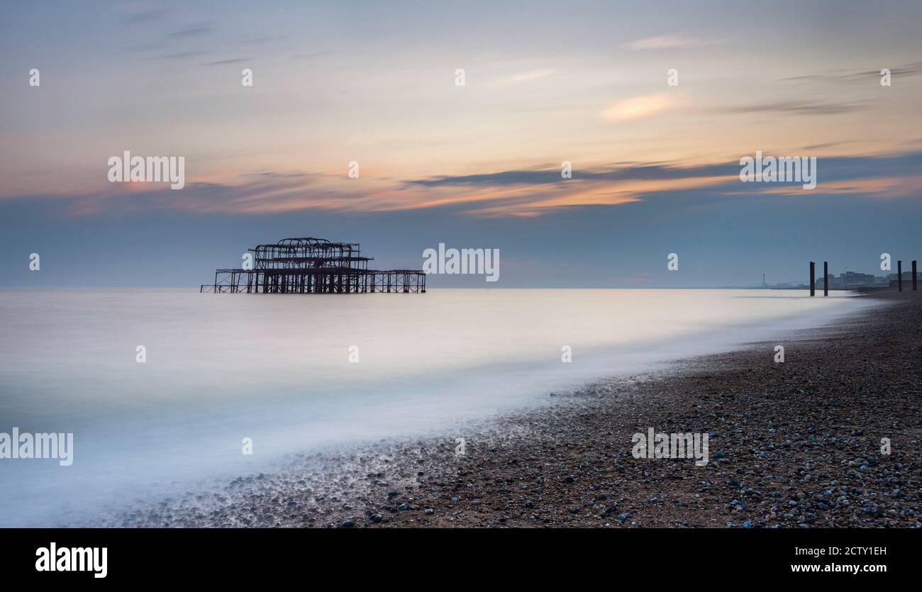 Long Exposure of a sunset behind the old ruined West Pier in Brighton, East Sussex, England Stock Photo
