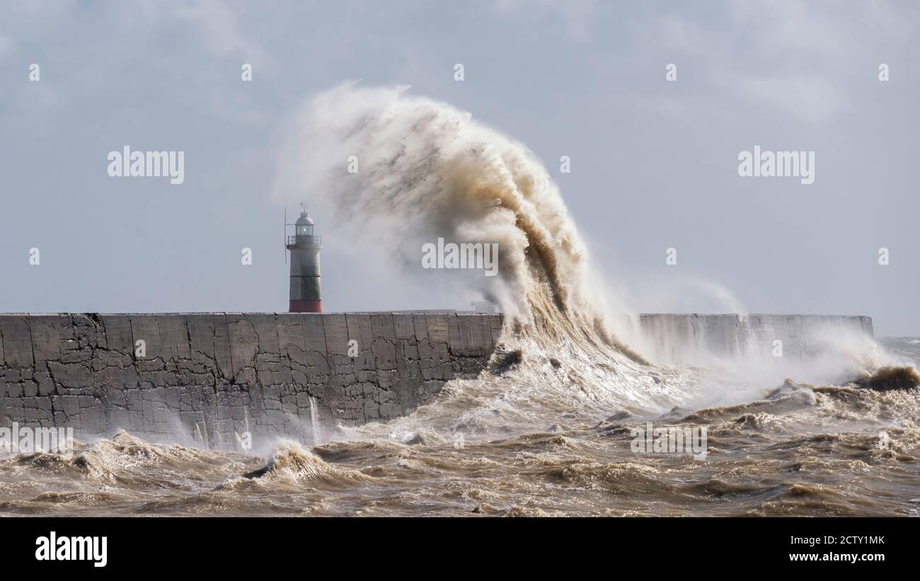 Storm waves breaking over the harbour arm and lighthouse at Newhaven, East Sussex, UK Stock Photo