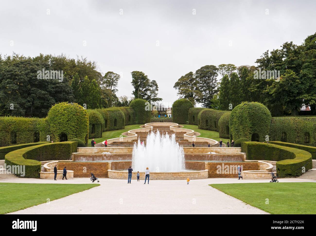 Families enjoy the Alnwick Gardens fountain. Stock Photo
