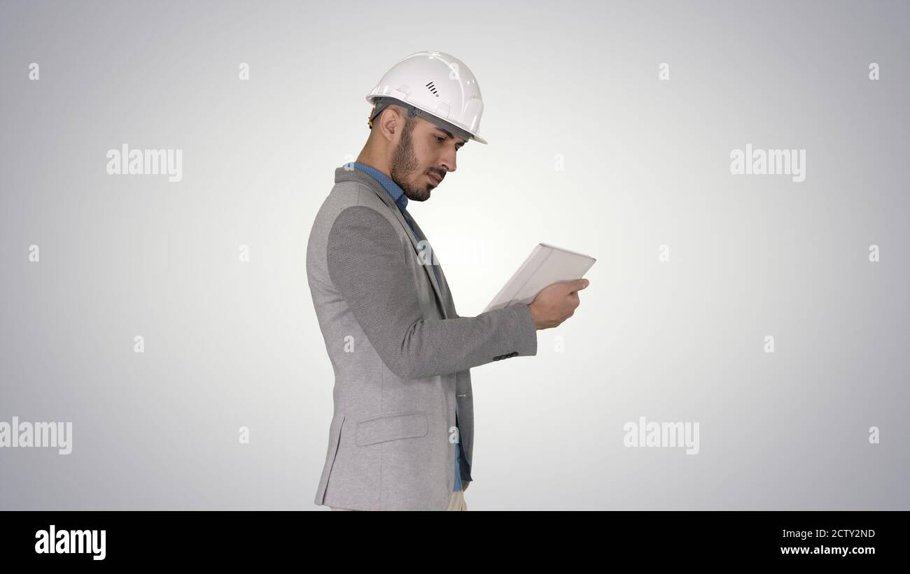 Engineer walking and working on digital tablet on gradient backg Stock Photo