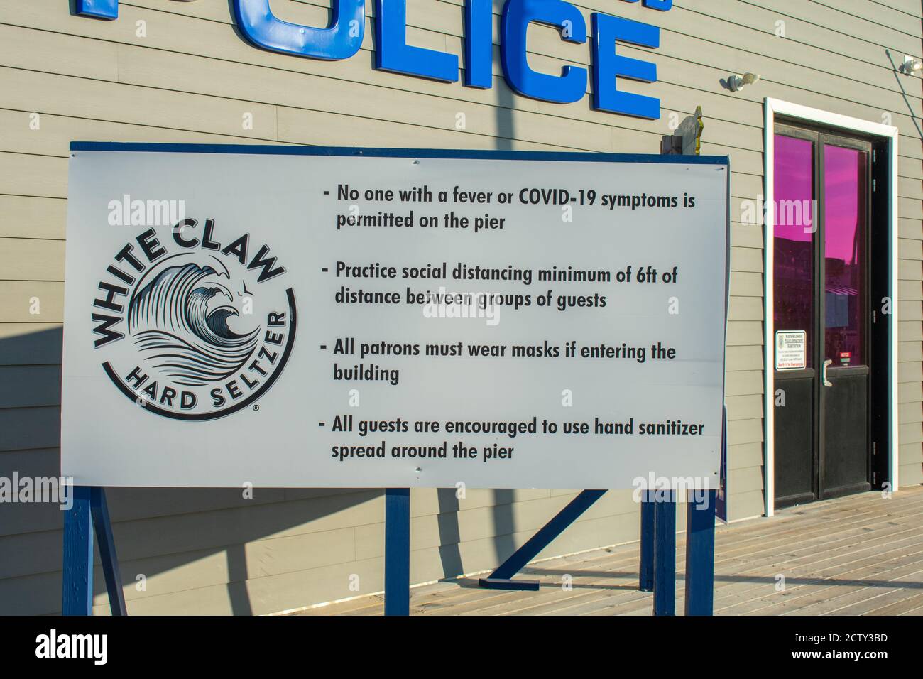 WILDWOOD, NEW JERSEY - AUGUST 8, 2018: A Sign on the Wildwood Boardwalk in Front of the Police Sation Stating Rules and Regulations During COVID-19 Stock Photo