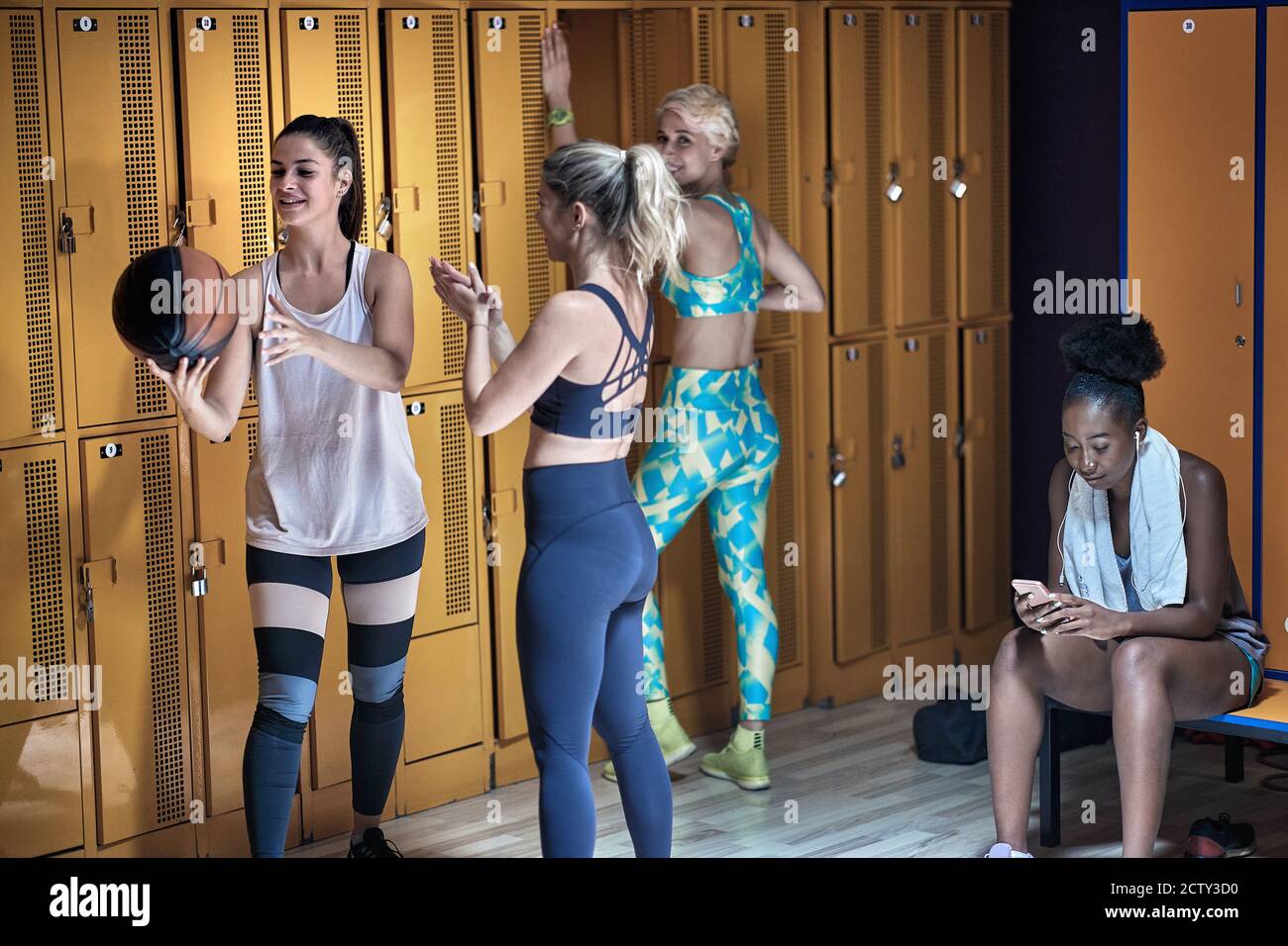 Young girls in a locker room relaxing after good training Stock Photo -  Alamy