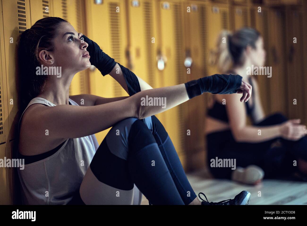Young girl chilling in a locker room after strenuous training Stock Photo