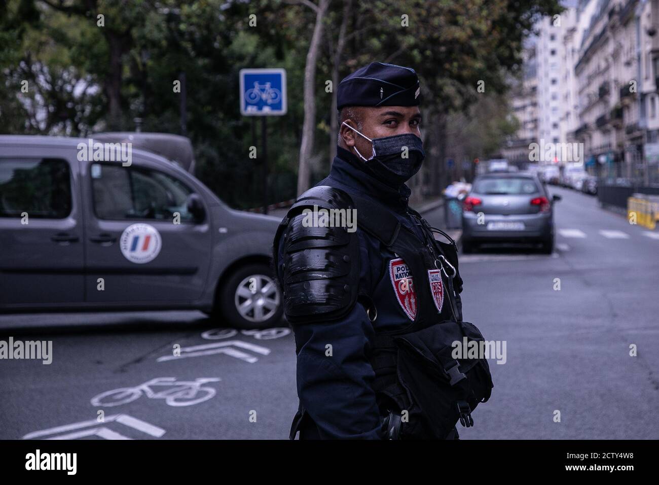 Police officer on guard at the premises where the attack occurred.Paris Police deploy a security operation around the former offices of Charlie Hebdo magazine following a stabbing attack on Boulevard Richard Lenoir. Stock Photo