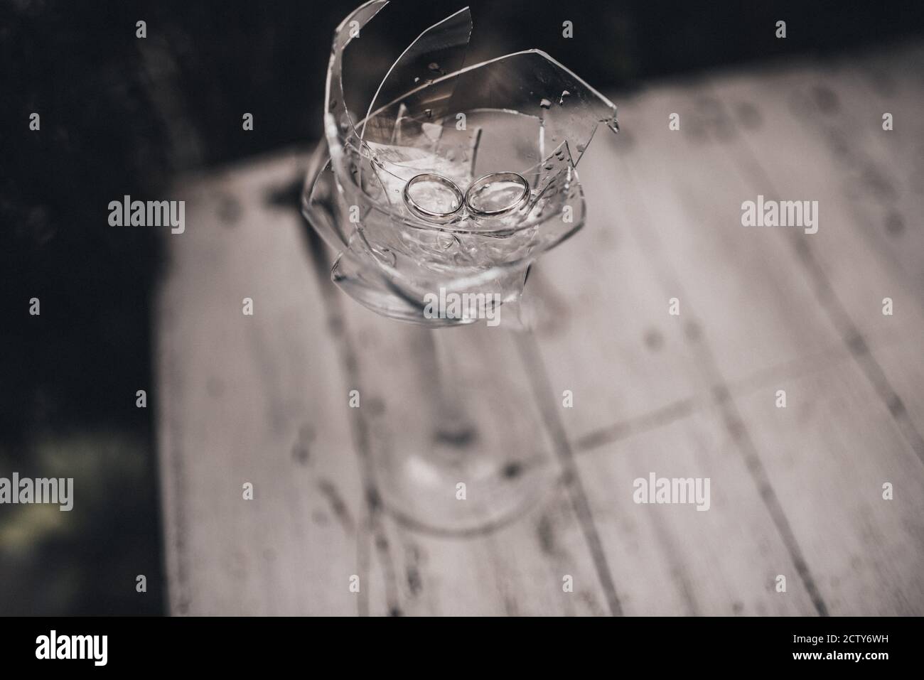 wedding rings in a broken crystal glass Stock Photo Alamy