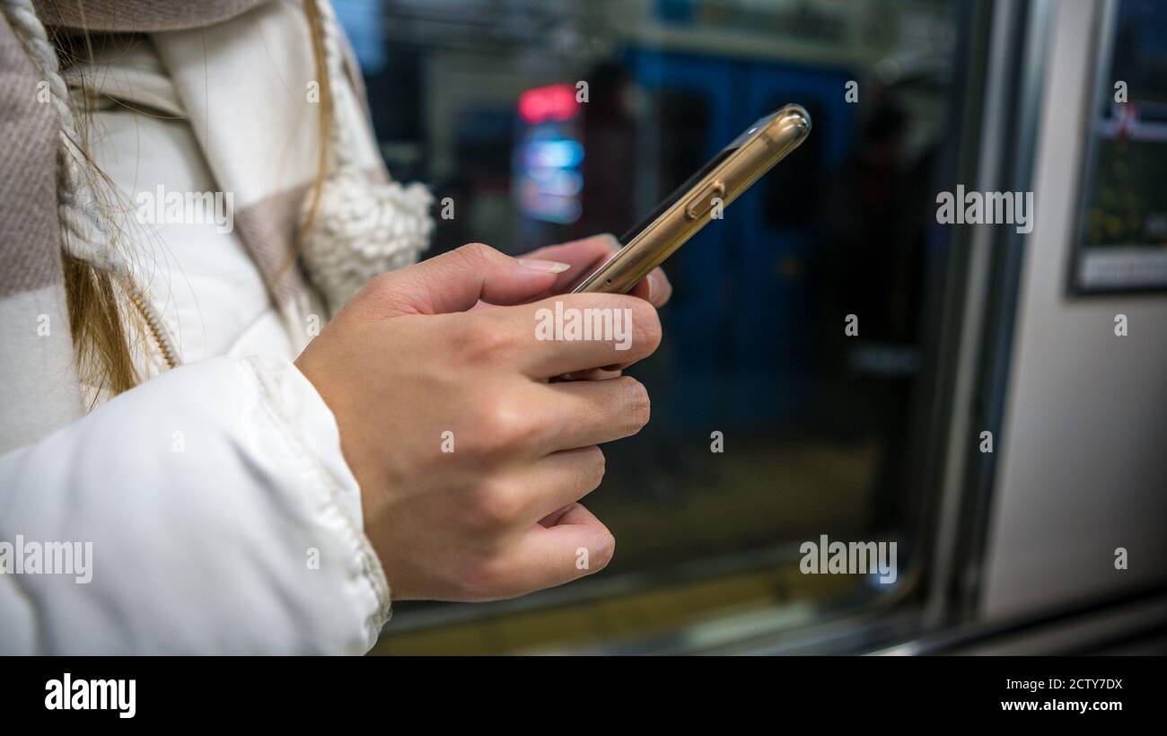 Wmata Using Phone Asian tourist woman holds smartphone inside of metro. Passenger using ...