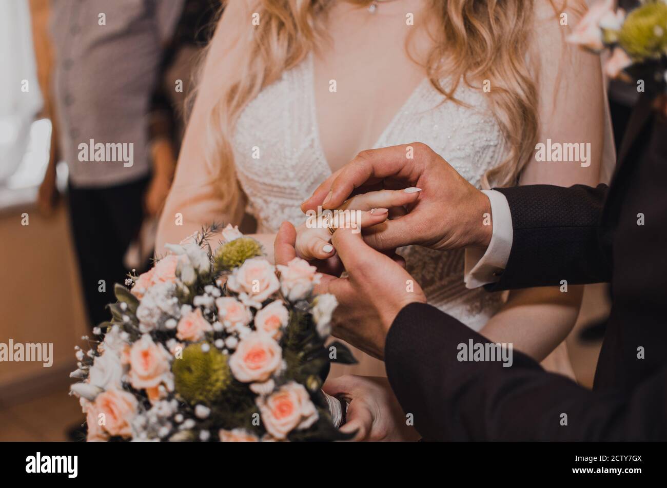The bride and groom puts a wedding ring Stock Photo - Alamy