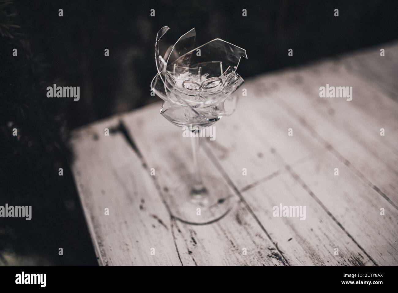 wedding rings in a broken crystal glass Stock Photo Alamy
