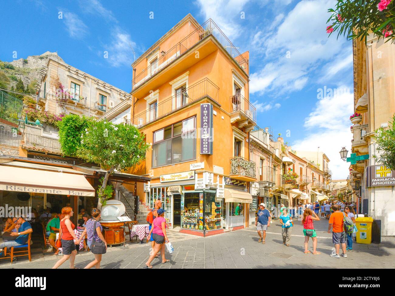 Busy section of Corso Umberto in Taormina, Italy on the Mediterranean island of Sicily on a warm summer day with crowds of tourists Stock Photo