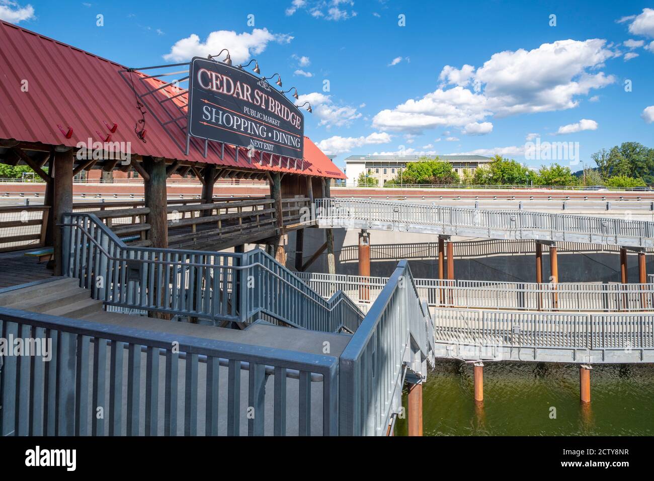 The Cedar Street Bridge Public Market of shopping and dining along Sand Creek River and Lake Pend Oreille in Sandpoint, Idaho, USA during summer. Stock Photo