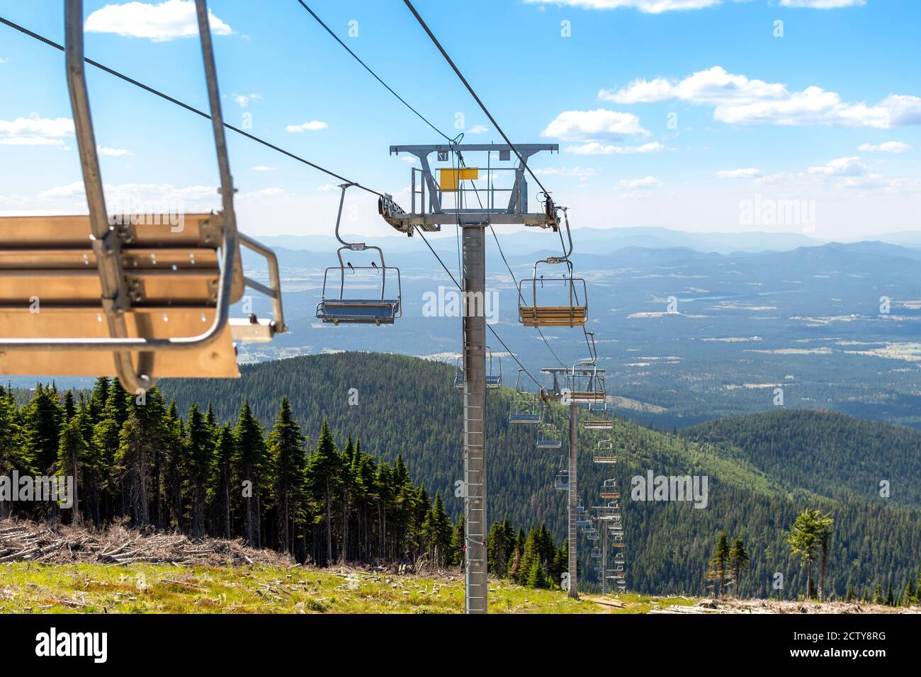 An empty ski lift not operating during summer at a Spokane State Park ski resort overlooking the Spokane, Washington area, USA Stock Photo