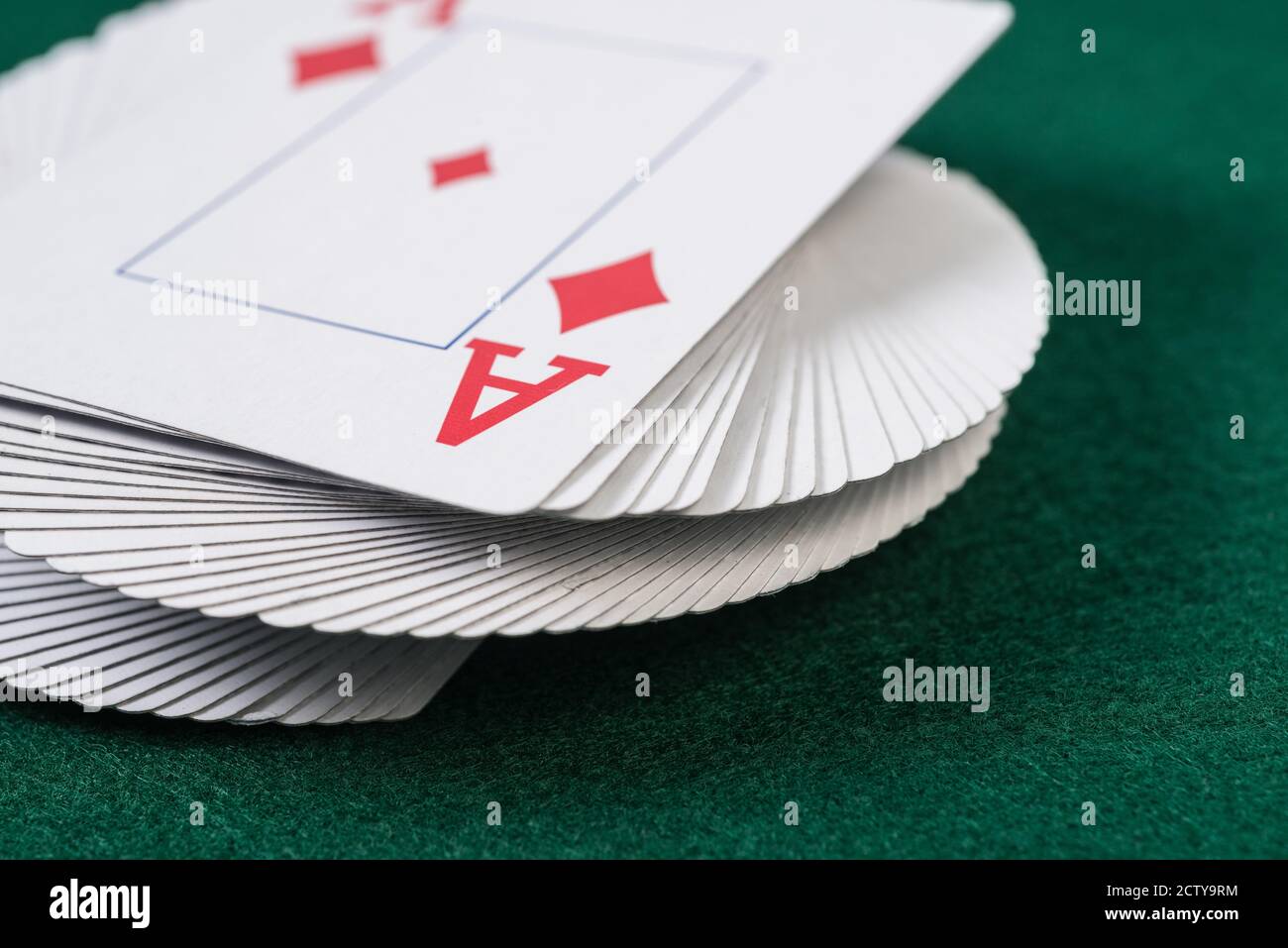 A close up deck of cards on top of gambling fabric. Stock Photo