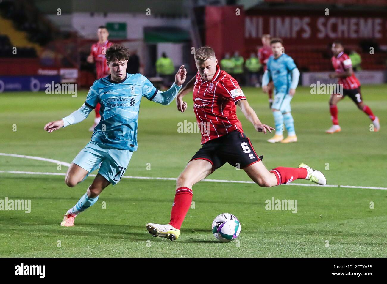 Lincoln City midfielder James Jones (8) and Liverpool defender Neco Williams (76) during the English League Cup, EFL Carabao Cup, football match betwe Stock Photo