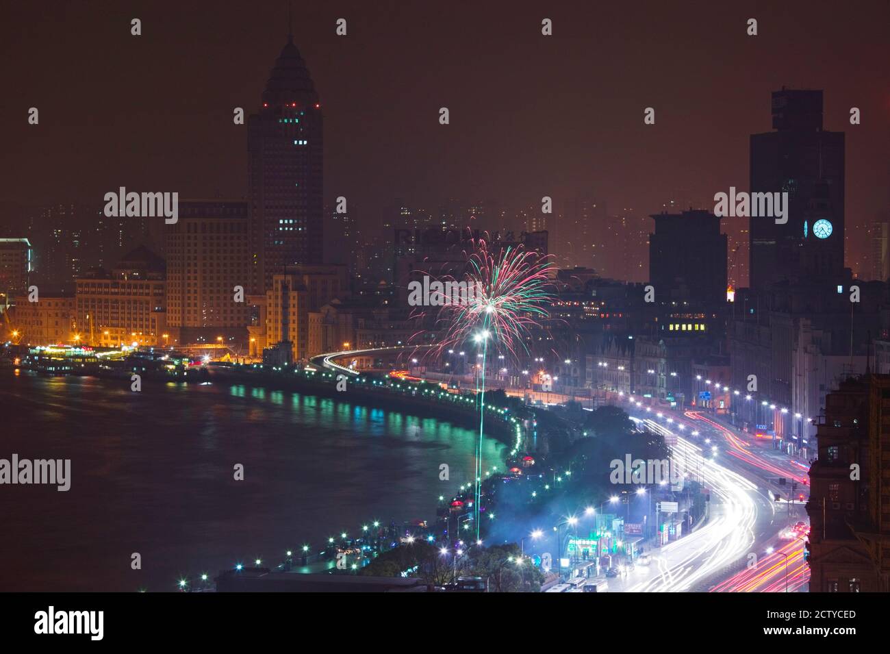 Fireworks display at dusk during Chinese New Year, The Bund, Shanghai, China Stock Photo