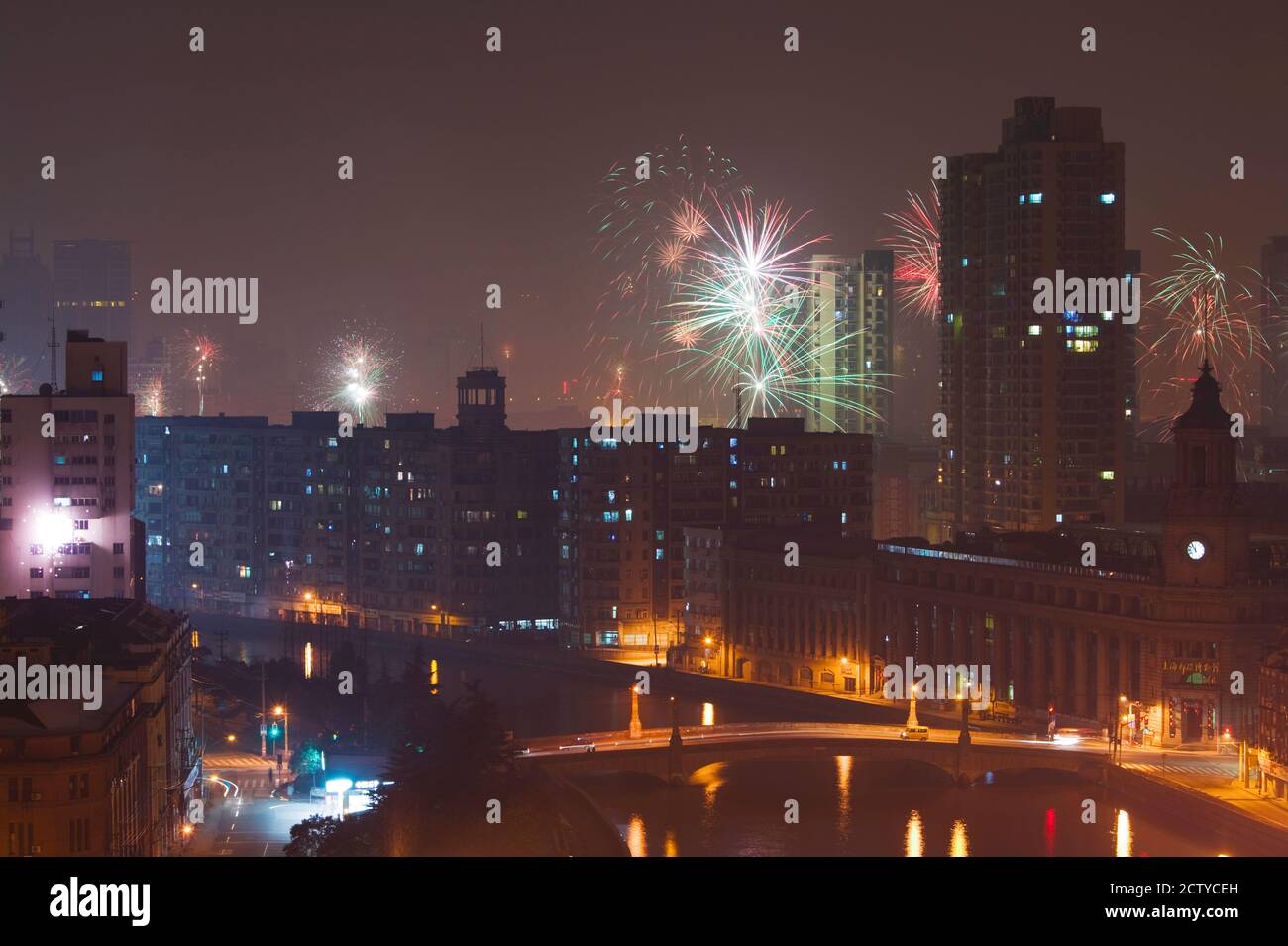 Fireworks over Suzhou Creek and Main Post Office during Chinese New year, Shanghai, China Stock Photo