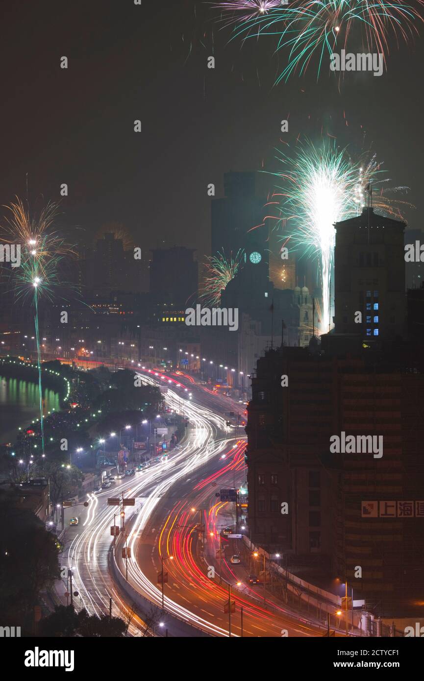 Fireworks display at dusk during Chinese New Year, The Bund, Shanghai, China Stock Photo
