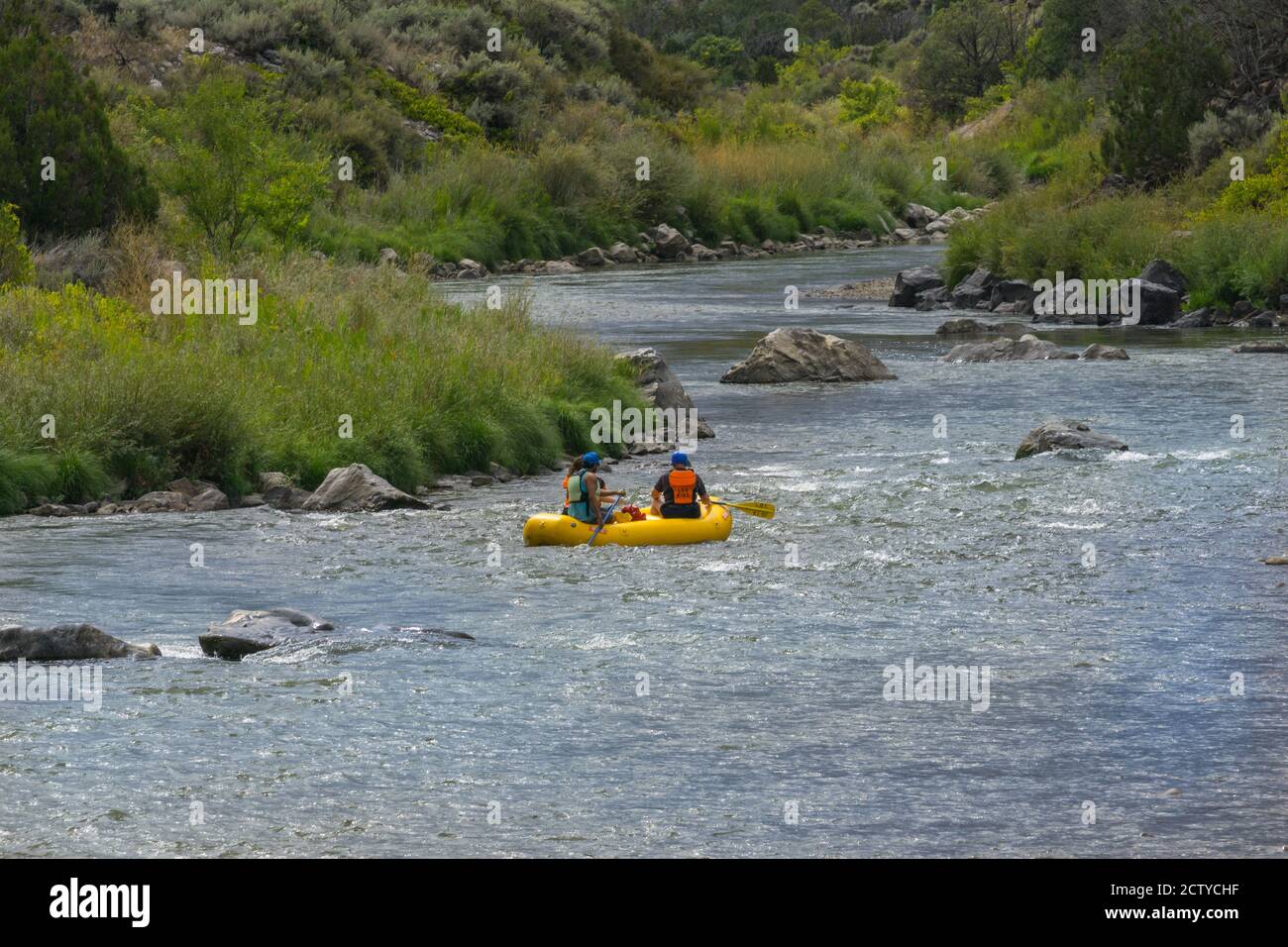 New Mexico -USA _ September 16 2015; Group of people paddling inflatable along Rio Grande river through landscape of New Mexico, USA. Stock Photo