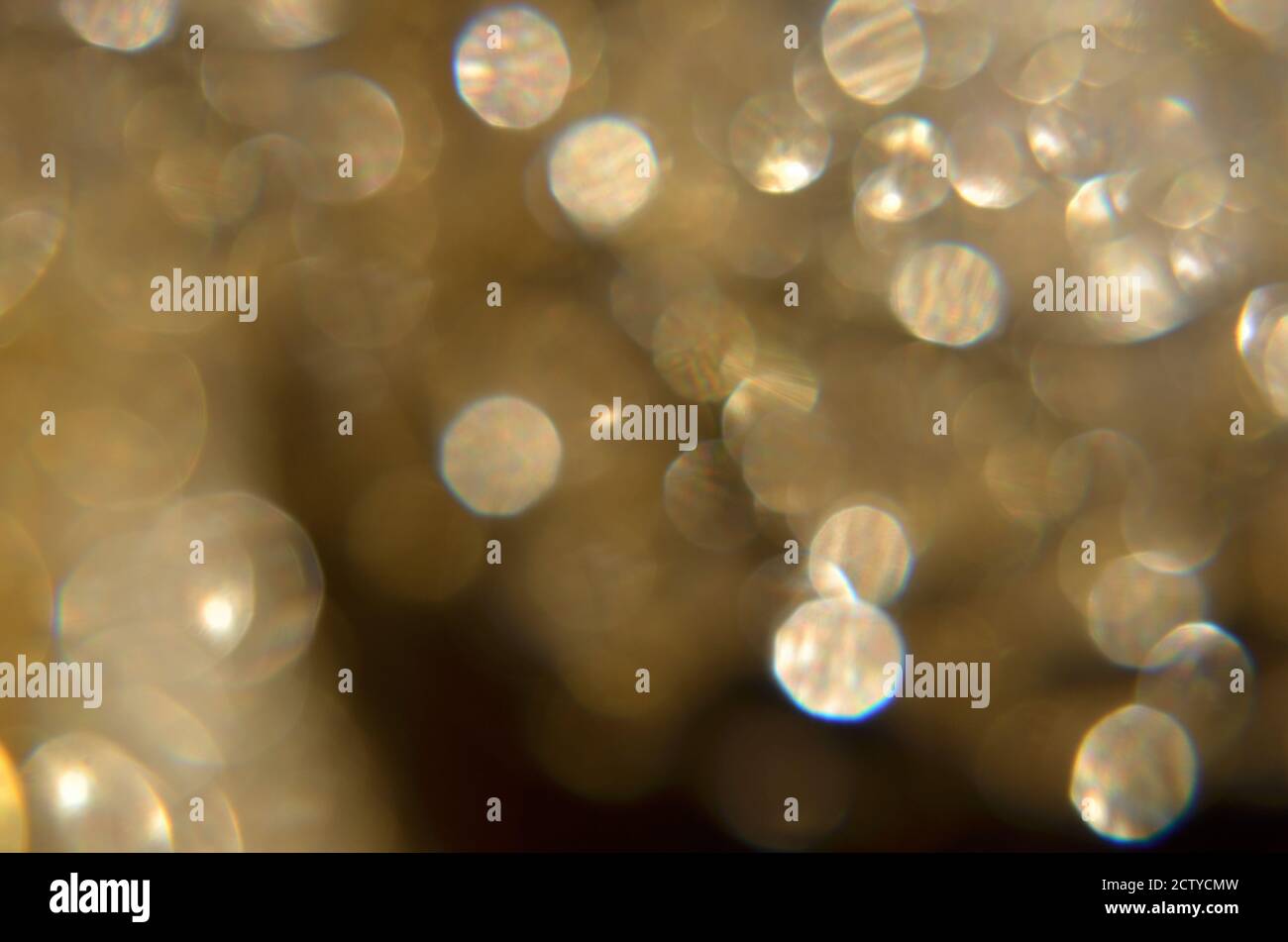 Shiny abstract background with festive defocused lights, golden bokeh. Christmas or New Year holiday concept. Stock Photo