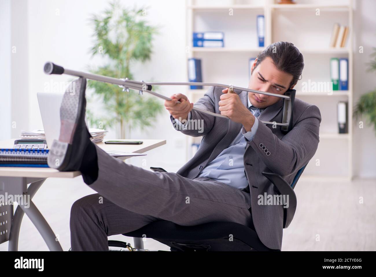 Young employee after accident at workplace Stock Photo