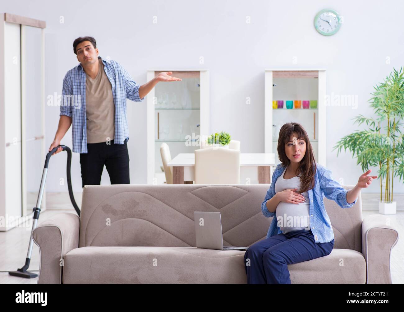 The man helping pregnant wife in cleaning Stock Photo Alamy