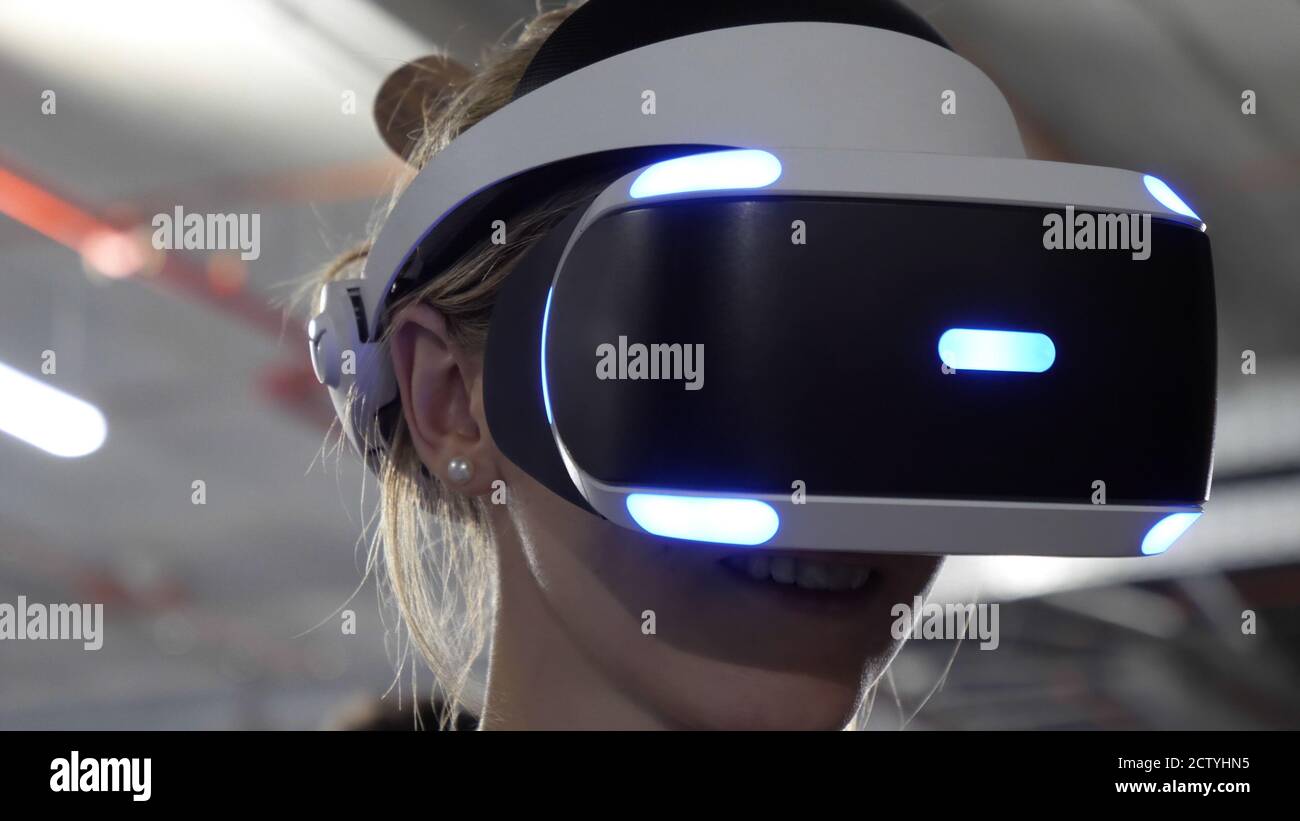Caucasian woman wearing a VR headset and smiling Stock Photo - Alamy