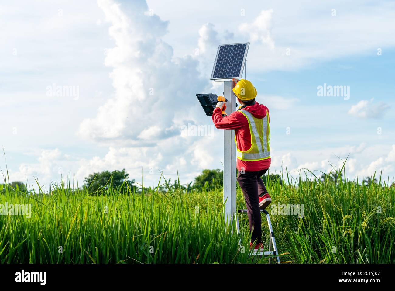 Asian technician install the maintenance of the solar panels, outdoor