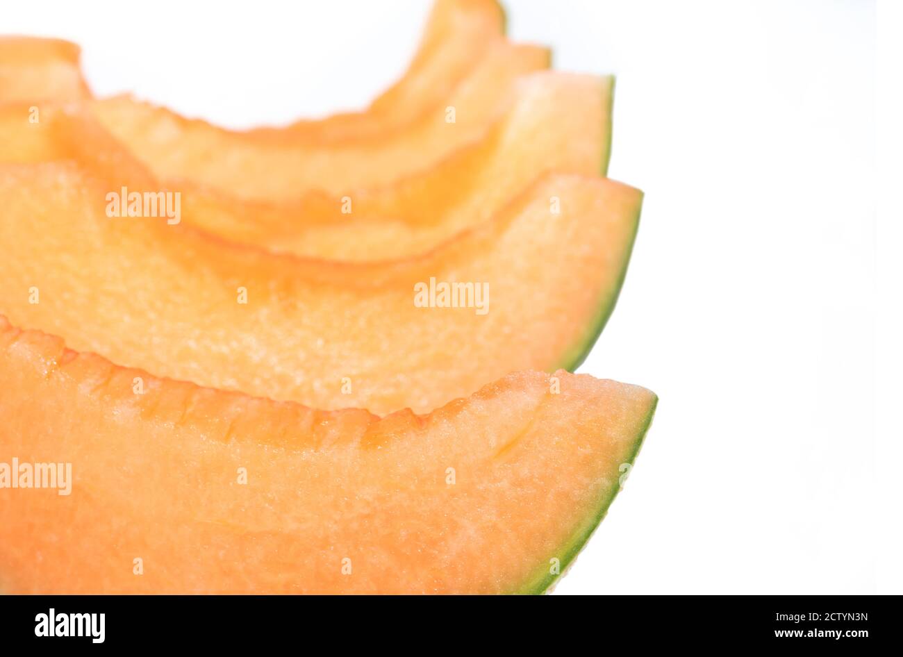 Cantaloupe melon cut in snack slices, no seeds. Also known as rockmelon, sweet melon or spanspek (Cucumis melo). Orange sweet flesh, netted rind. Stock Photo