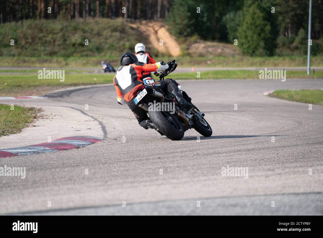 Motorcycle practice leaning into a fast corner on track Stock Photo Alamy