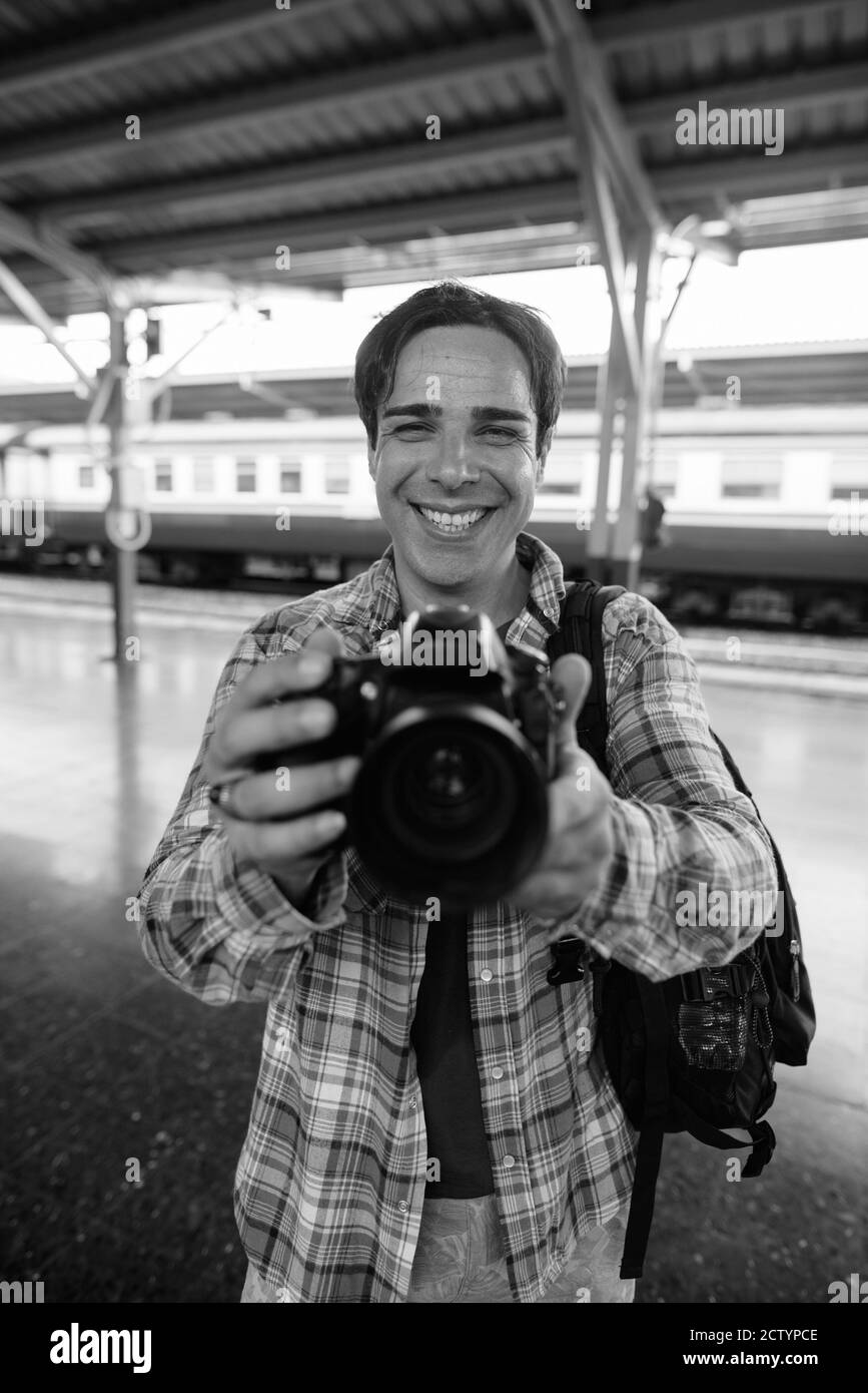 Portrait of handsome Persian tourist man at the railway station Stock Photo