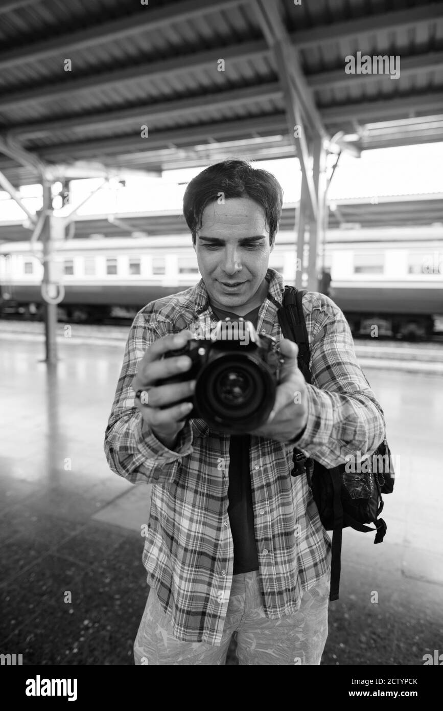 Portrait of handsome Persian tourist man at the railway station Stock Photo