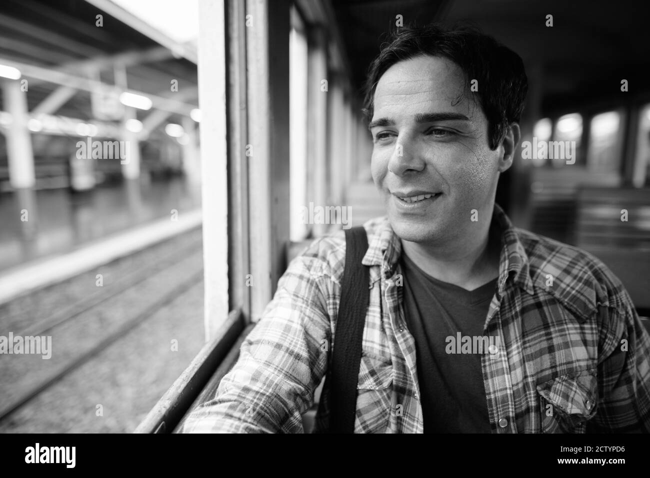 Portrait of handsome Persian tourist man at the railway station Stock Photo