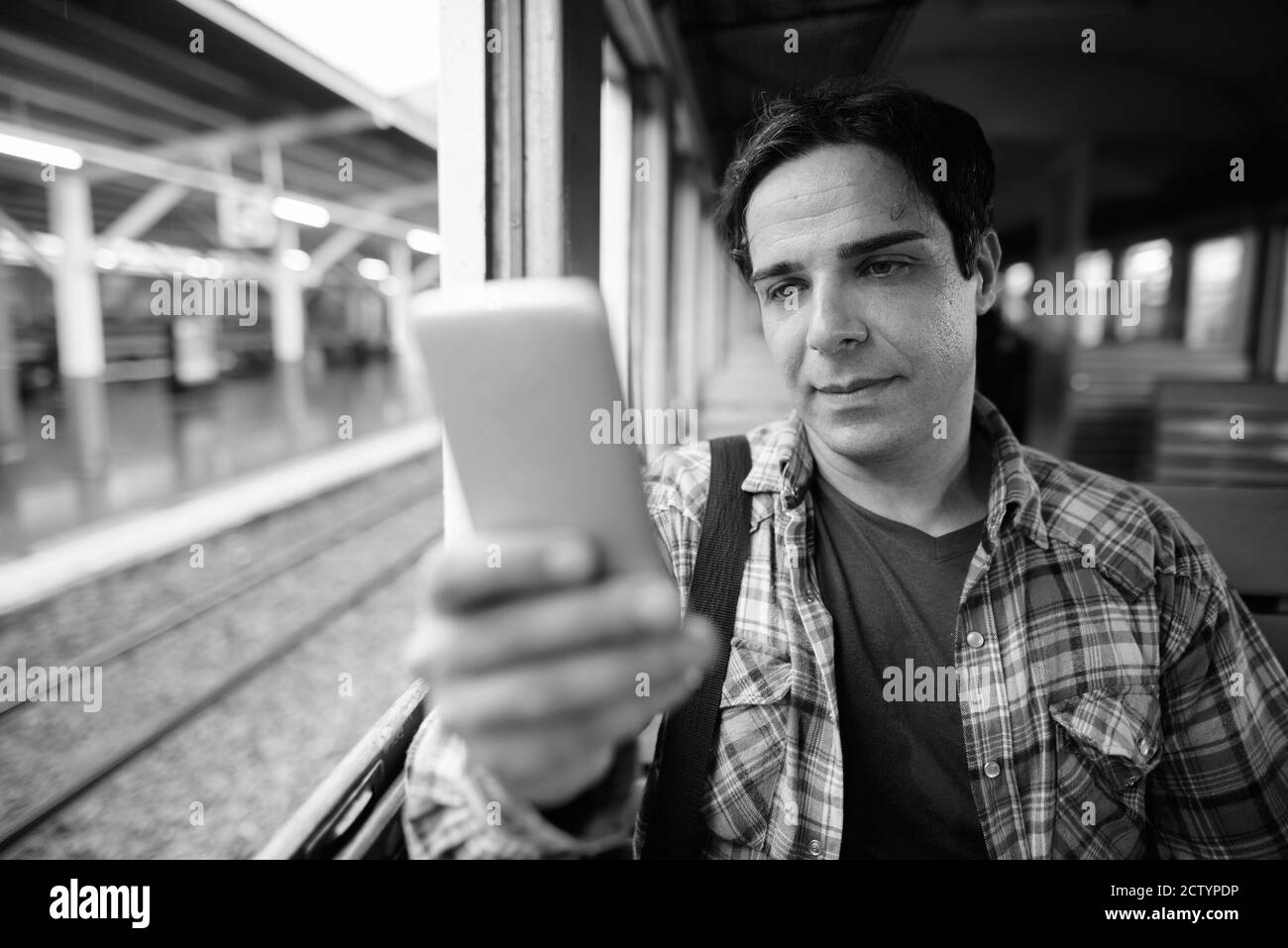 Portrait of handsome Persian tourist man at the railway station Stock Photo