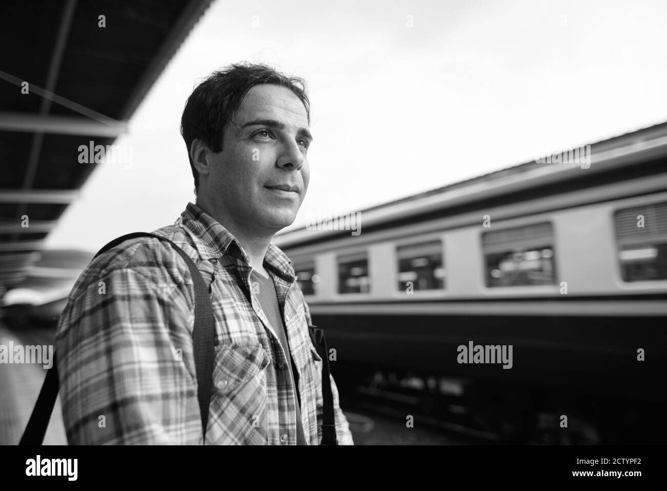 Portrait of handsome Persian tourist man at the railway station Stock Photo