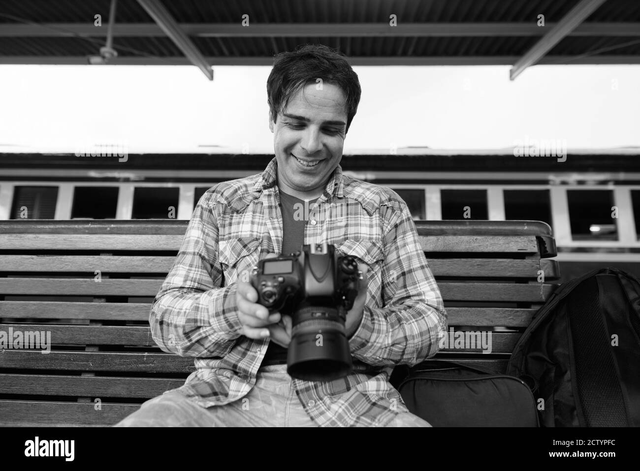 Portrait of handsome Persian tourist man at the railway station Stock Photo