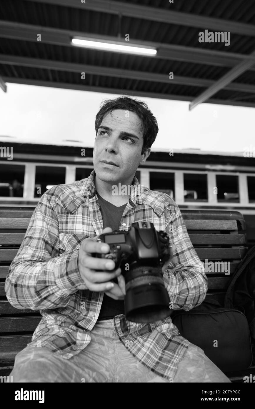 Portrait of handsome Persian tourist man at the railway station Stock Photo