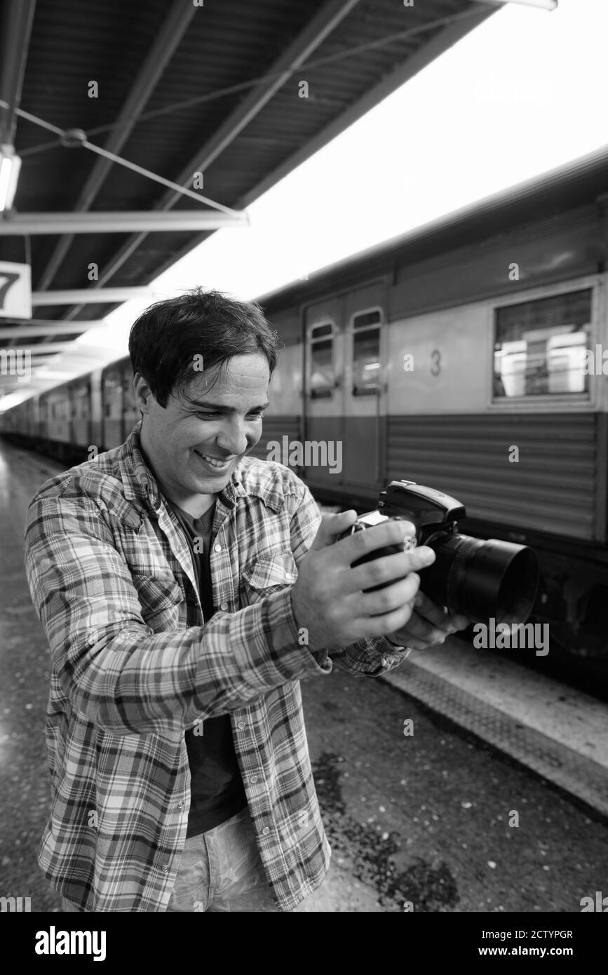 Portrait of handsome Persian tourist man at the railway station Stock Photo