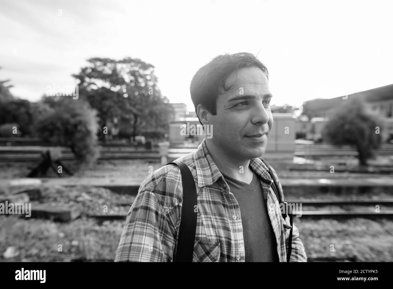 Portrait of handsome Persian tourist man at the railway station Stock Photo